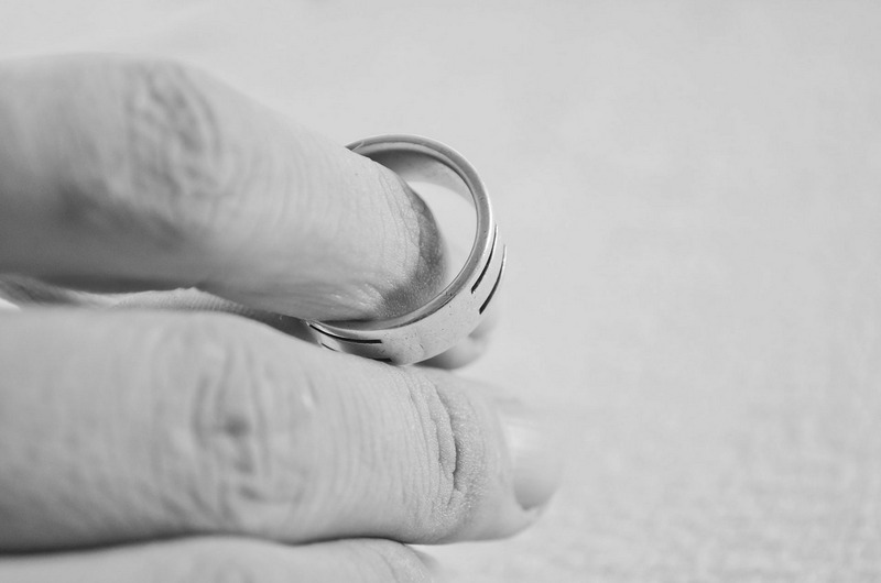 Hand holding ring after extramarital affair