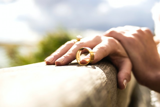 Picture of a person holding their wedding band for the blog about when it's time to divorce